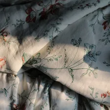 a close up of a bed sheet with a flower pattern related to Elevate Your Bedroom with Shabby Chic Bedding