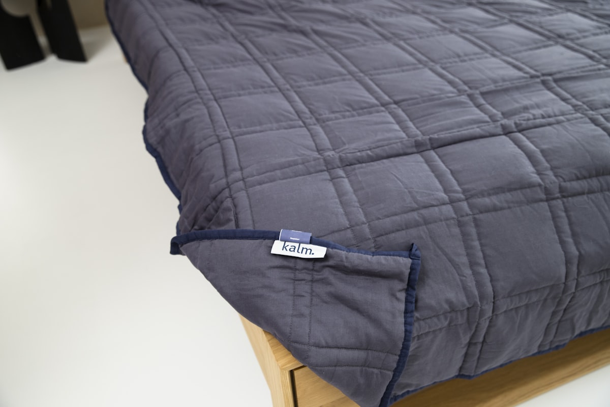 a close up of a bed with a label on it related to King Size Quilts and Coverlets: Ultimate Bedroom Comfort