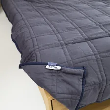 a close up of a bed with a label on it related to King Size Quilts and Coverlets: Ultimate Bedroom Comfort