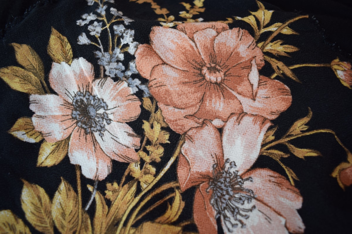 A close up of a black and pink flowered fabric related to Black Floral Valance: Elevating Your Home Decor