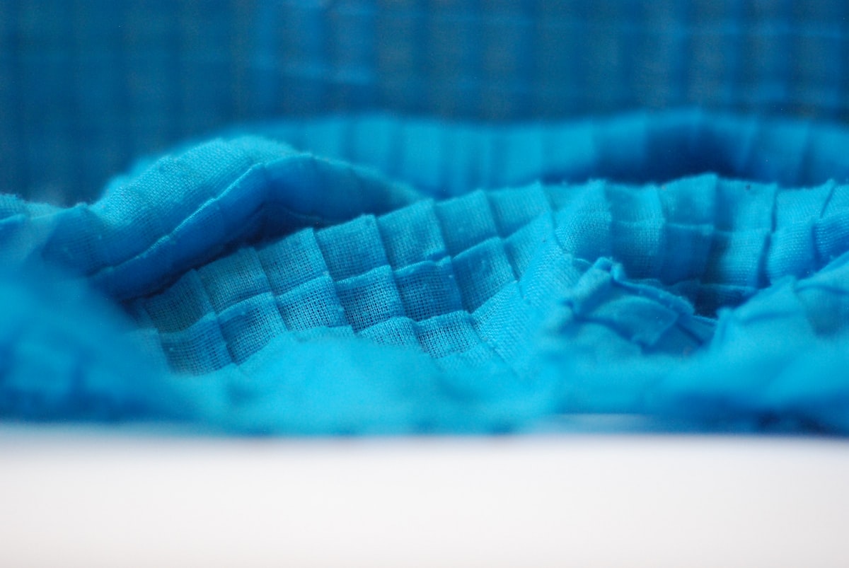 a close up of a blue cloth on a table related to Aqua Quilts Coverlets