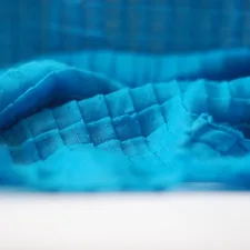 a close up of a blue cloth on a table related to Aqua Quilts Coverlets