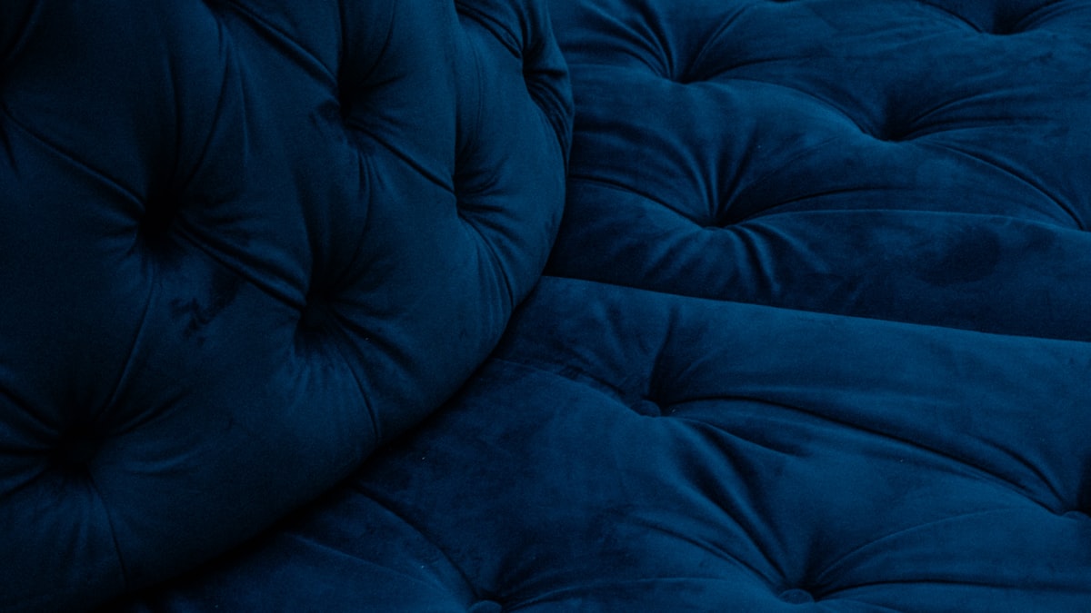 a close up of a blue couch cushion related to Velvet Coverlets and Quilts