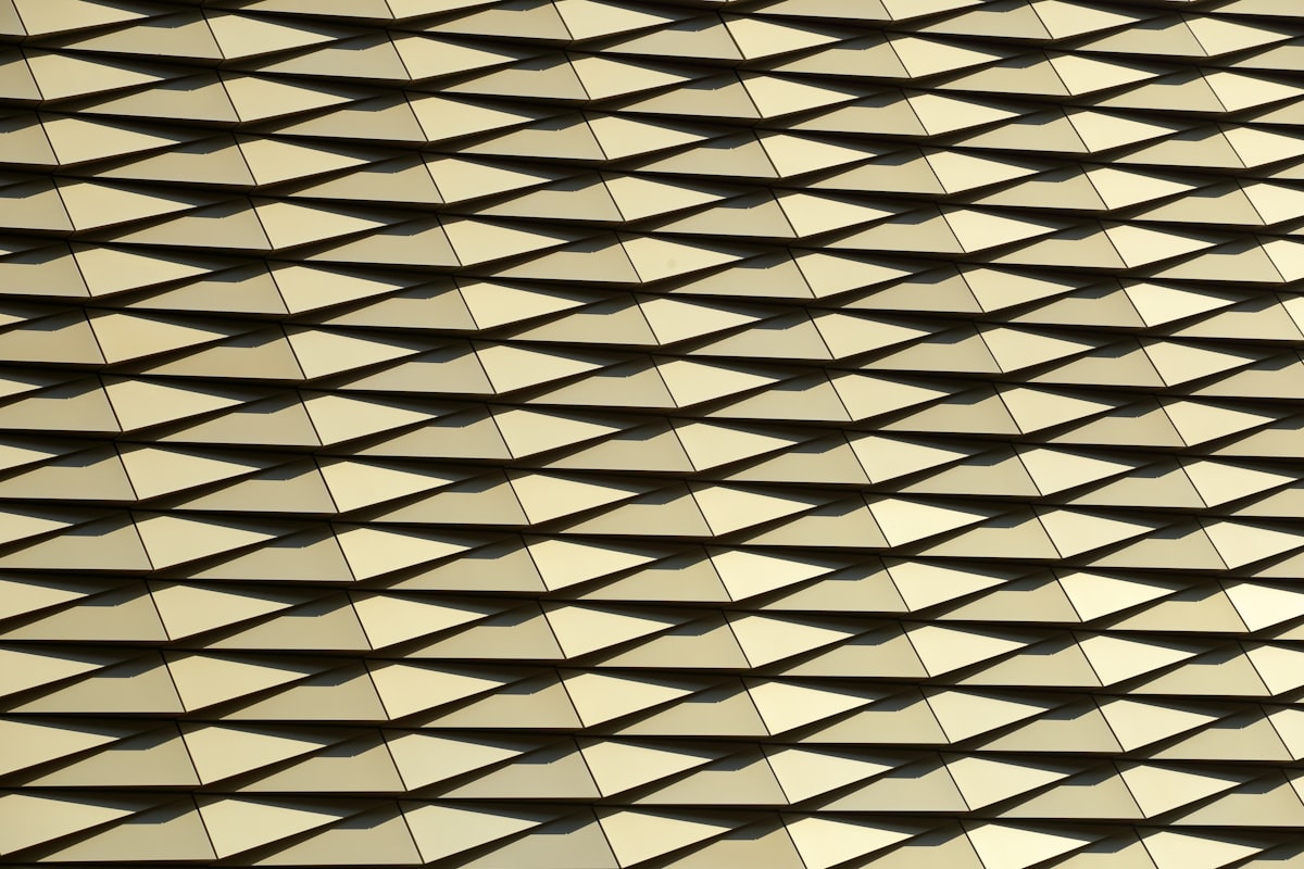 a close up of a building with many squares on it related to Gold Quilted Coverlet: A Luxurious Bedding Option