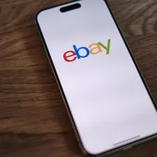 A close up of a cell phone on a table related to Elevate Your Home Decor with eBay's Exquisite Sideboards and Buffets