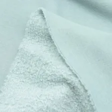 a close up of a light blue fabric related to Soft Comfort with Style: Cotton Coverlets and Quilts