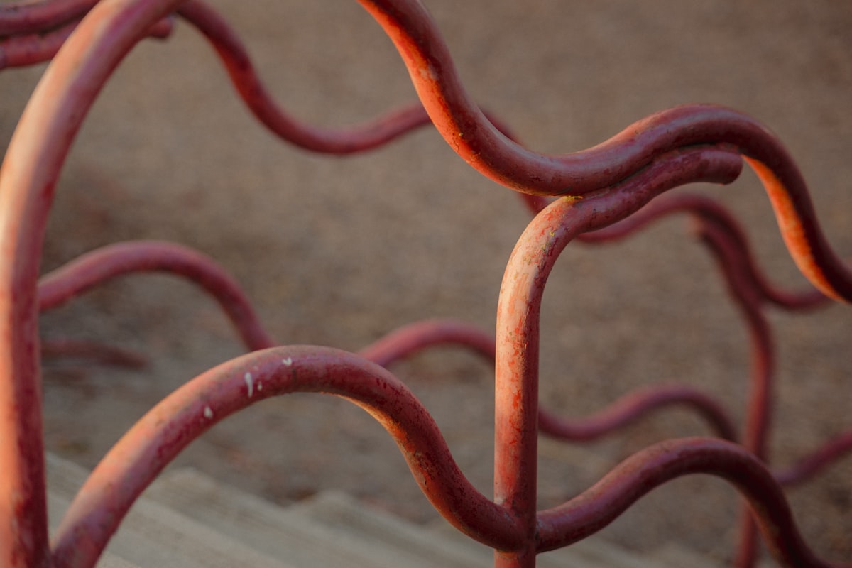 a close up of a metal fence with red paint related to The Anatomy of Iron Bed Frames: A Guide to Choosing the Perfect One