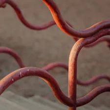 a close up of a metal fence with red paint related to The Anatomy of Iron Bed Frames: A Guide to Choosing the Perfect One