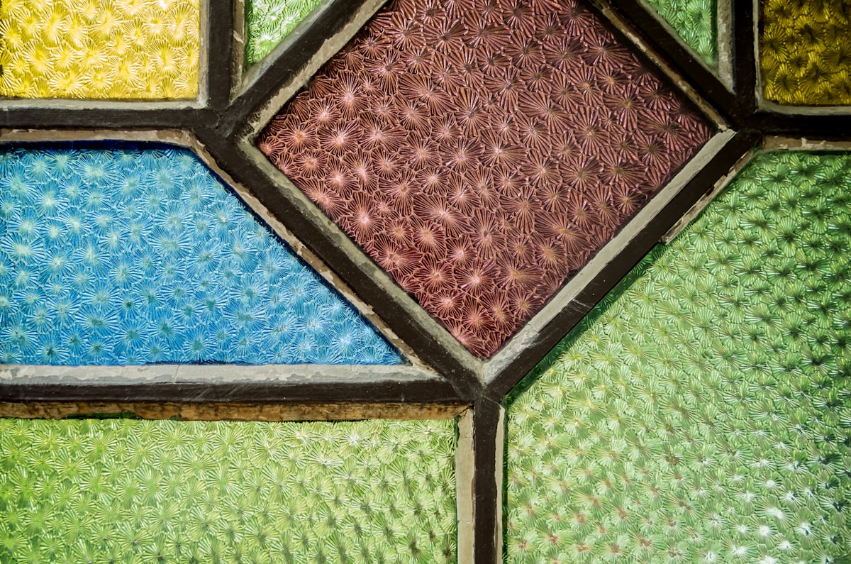 a close up of a multicolored stained glass window related to Elegance in Light: The Art of Stained Glass Valances
