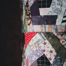 a close up of a patchwork wall hanging related to The Future of Quilting: Modern Quilts and Coverlets