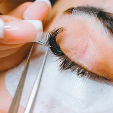 A close up of a person cutting a persons eye related to Coverlet Eye Patches: Expertly Crafted for Optimal Comfort