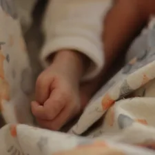 a close up of a person laying in a bed related to Noah's Ark Baby Bedding: Create a Whimsical Nursery with Timeless Charm