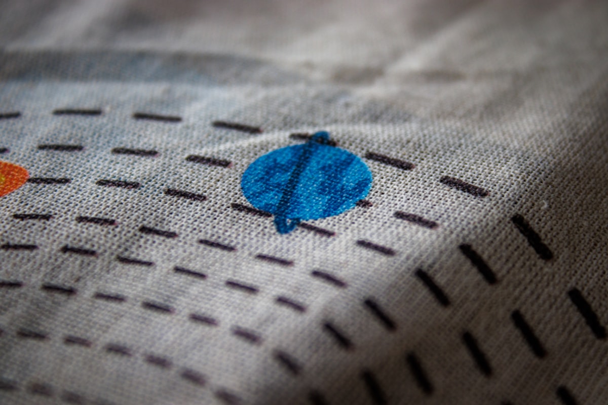 a close up of a piece of cloth with a design on it related to Create a Cozy Ocean-Themed Bedroom