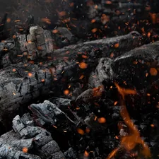 a close up of a pile of wood and fire related to The Ultimate Guide to Chiminea Cast Iron: Everything You Need to Know