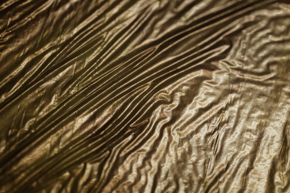 a close up of a white fabric related to Gold Bed Skirt: Elevate Your Bedroom with Luxury and Elegance