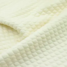 a close up of a white quilted material related to Ivory Matelassé Coverlet