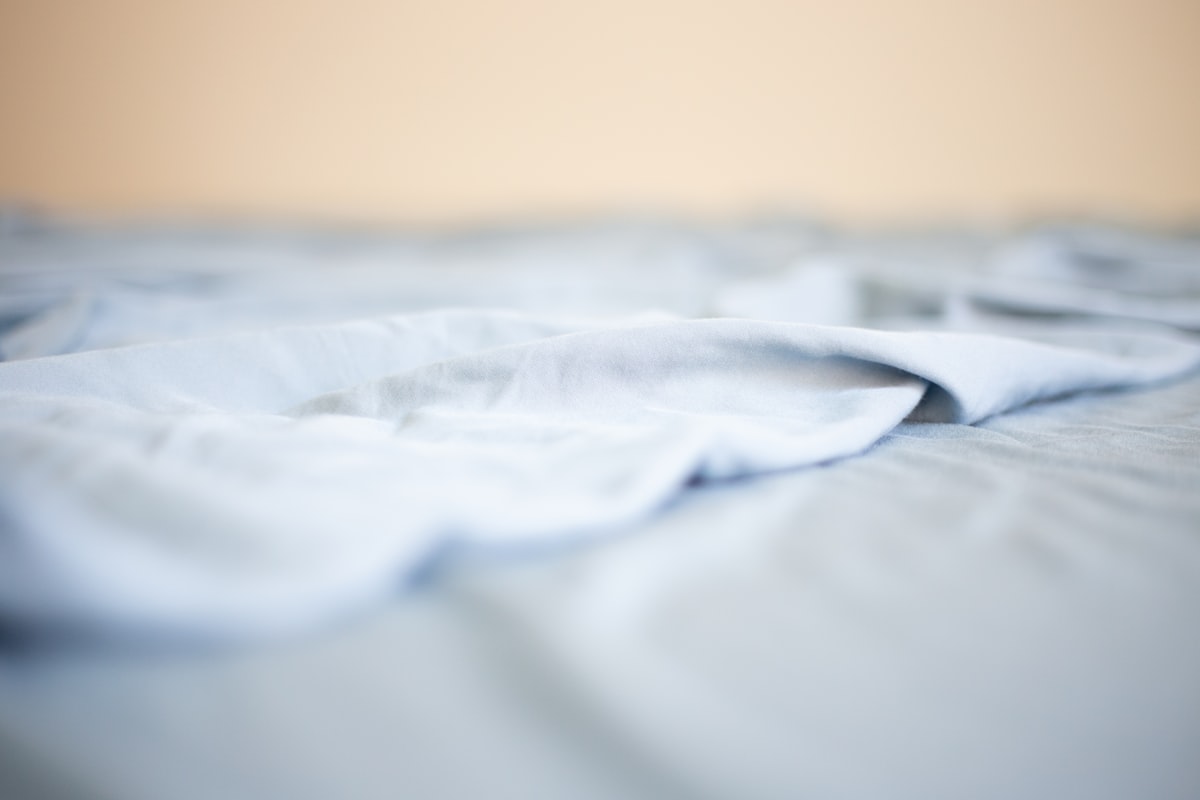 a close up of a white sheet on a bed related to Twin XL Coverlet