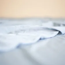 a close up of a white sheet on a bed related to Twin XL Coverlet