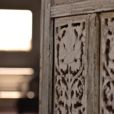 A close up of a wooden door with a window in the background related to 10 Unique White Distressed Sideboard Ideas to Elevate Your Home Decor