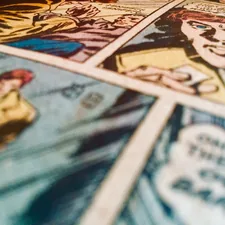 a close up of comics on a table related to Transform Your Bedroom with Comic Book Bedding: A Fun and Unique Style