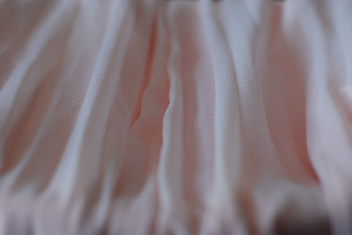 a close up view of a pink fabric related to Timeless Elegance: The Bed Skirt Queen