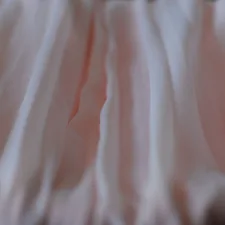 a close up view of a pink fabric related to Timeless Elegance: The Bed Skirt Queen