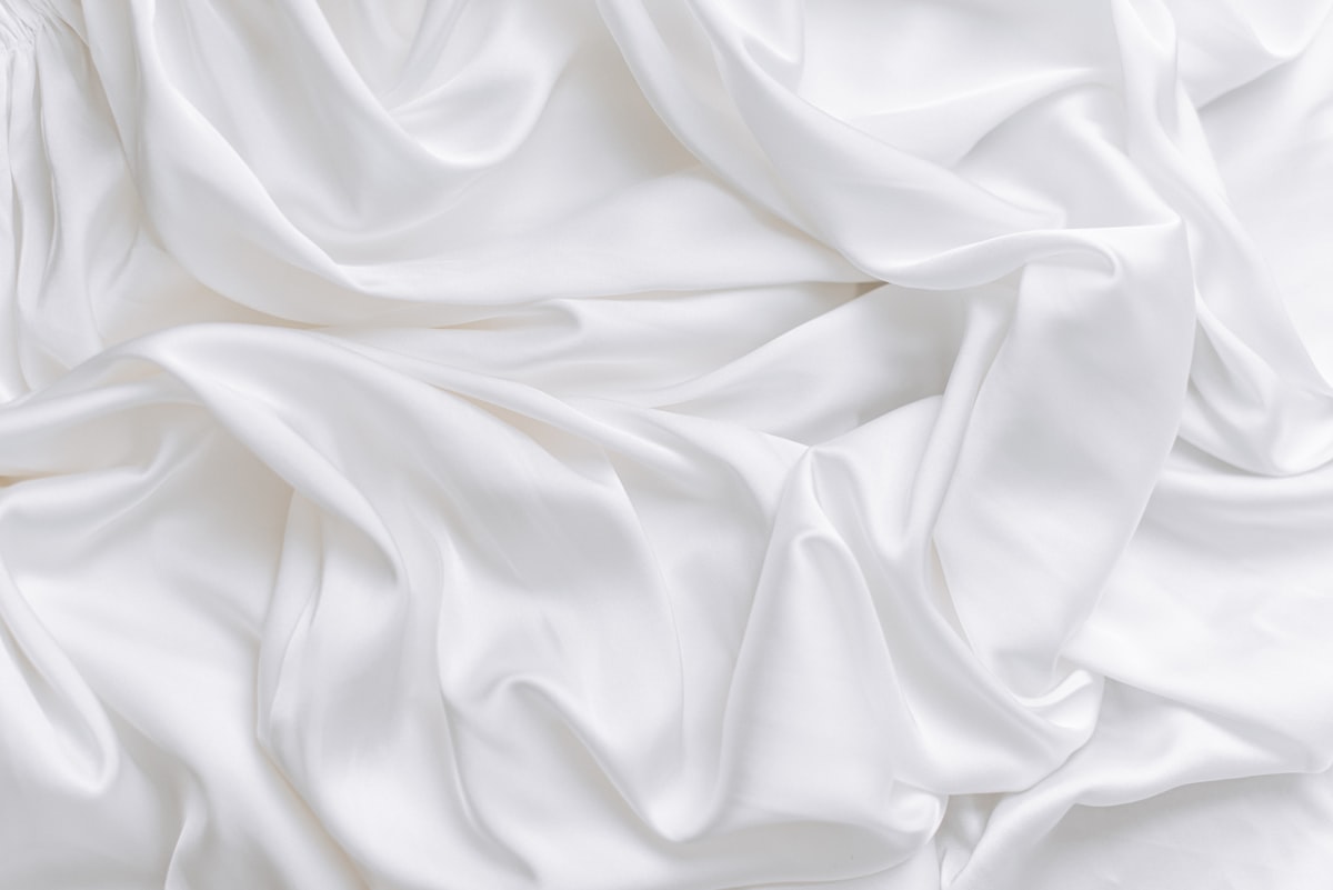 a close up view of a white fabric related to Luxurious Silk Coverlets for Queen-Sized Beds