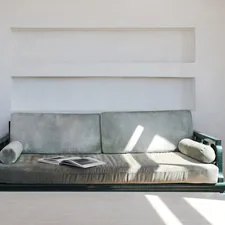 A couch sitting in a living room next to a window related to Mastering Multi-Functional Living with Convertible Sofa Beds