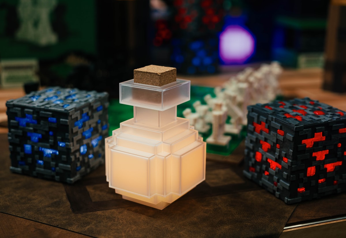 a couple of blocks sitting on top of a table related to Minecraft Bed Set Dreams: The Ultimate Sleeping Experience for Gamers