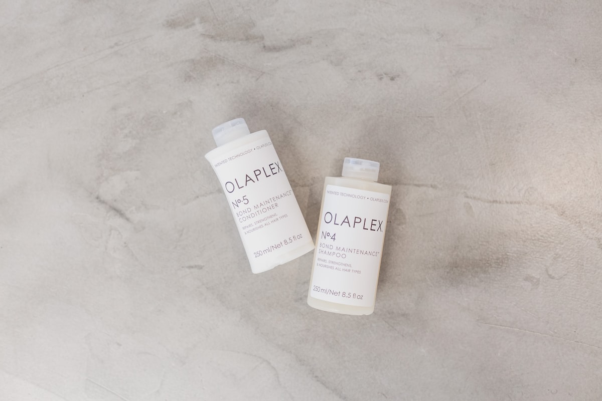 a couple of bottles of soap sitting on top of a table related to Say Goodbye to Bed Head: The Ultimate Guide to Shampoo and Conditioner