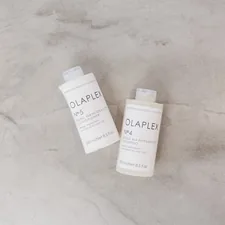a couple of bottles of soap sitting on top of a table related to Say Goodbye to Bed Head: The Ultimate Guide to Shampoo and Conditioner
