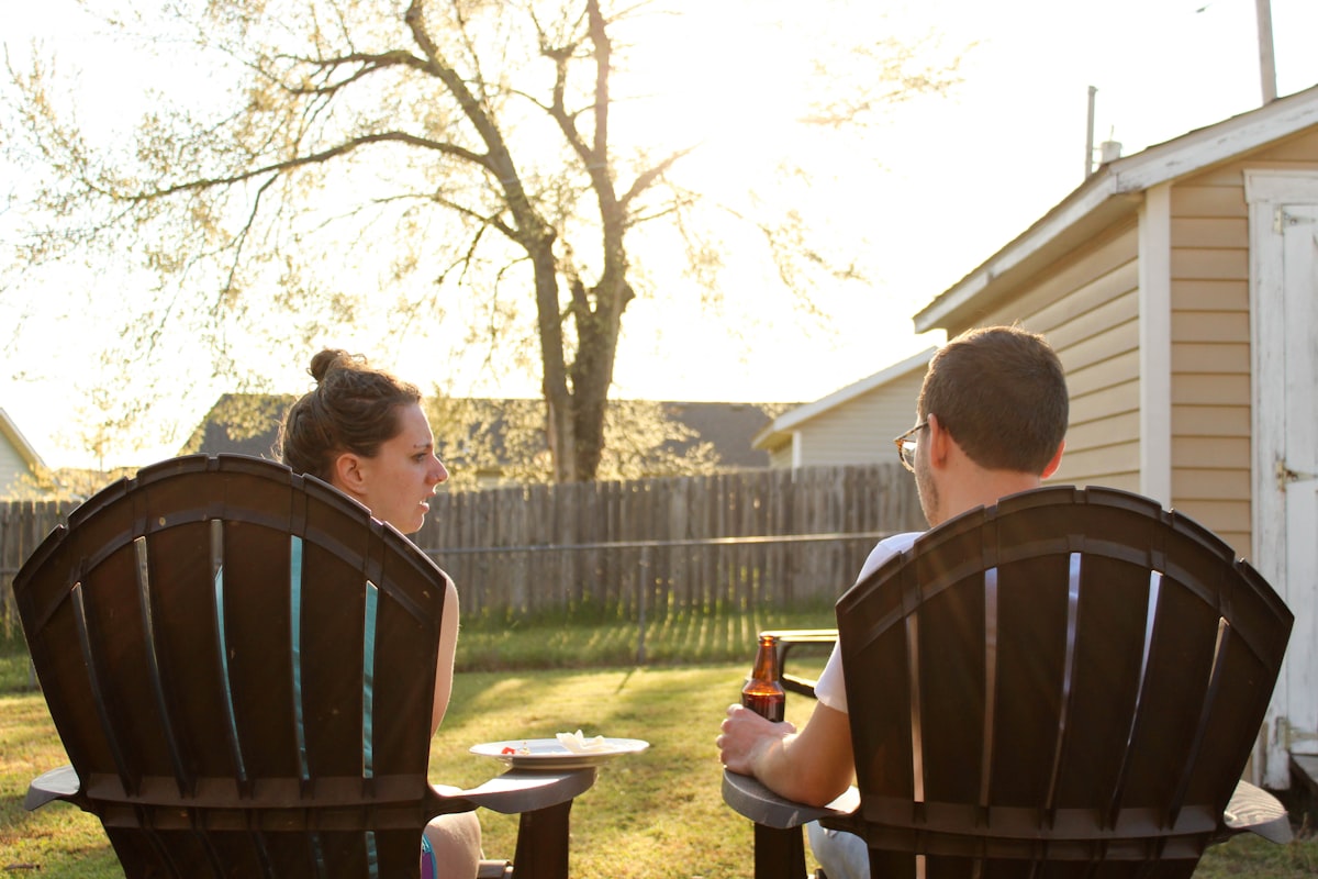 a couple of people sitting in lawn chairs related to Elevate Your Backyard Ambiance with a Chiminea Stand Iron