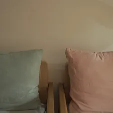 a couple of pillows sitting on top of a wooden chair related to Best Bed Chair Pillows for Comfort and Support
