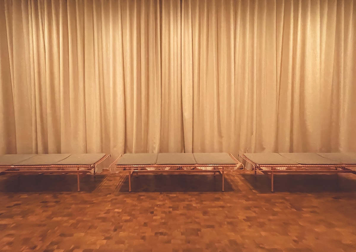 a couple of tables sitting on top of a hard wood floor related to Beds That Sit on the Floor: A Comprehensive Guide