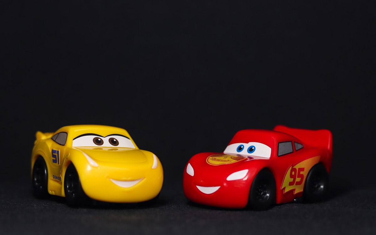 a couple of toy cars sitting next to each other related to Rev Up Your Child's Sleep: A Guide to Cars Toddler Bed Sets
