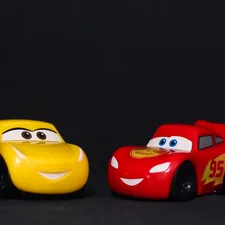 a couple of toy cars sitting next to each other related to Rev Up Your Child's Sleep: A Guide to Cars Toddler Bed Sets