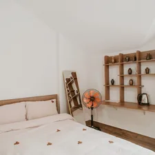 A cozy bedroom decorated with wooden accents. related to Maximize Your Space: The Ultimate Guide to Bed with Shelves