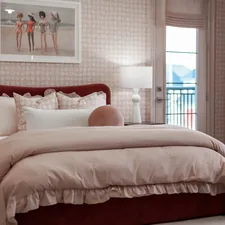 A cozy bedroom with a large bed and soft lighting. related to Unraveling the Elegance: The Fashion Bed Group