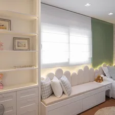 A cozy bedroom with a window seat and shelves. related to Nursery Valance Curtains: Add a Touch of Elegance to the Nursery