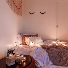 a cozy boho room decor with candles and string lights related to Cozy Nights Ahead: Elevating Home Decor with Quilts & Coverlets Bedding