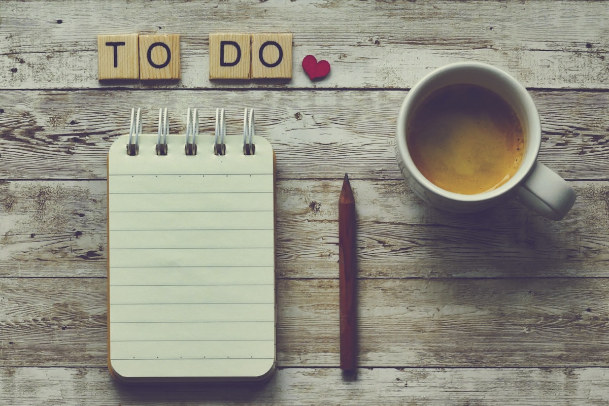 a cup of coffee next to a notepad with the words to do on it related to What to Do If You Have Bed Bugs: A Comprehensive Guide