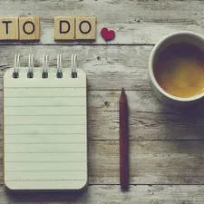 a cup of coffee next to a notepad with the words to do on it related to What to Do If You Have Bed Bugs: A Comprehensive Guide