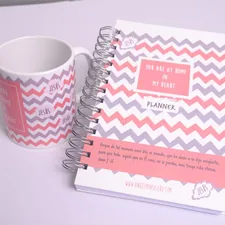 a cup of coffee next to a planner related to Pink and Grey Chevron Crib Bedding: A Stylish Nursery Must-Have