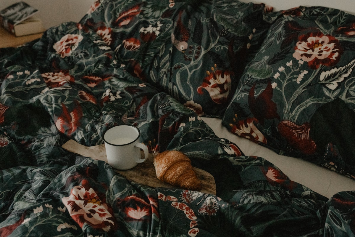 a cup of coffee on a bed related to King Size Coverlet Sets
