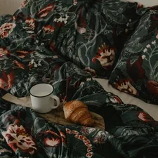 a cup of coffee on a bed related to King Size Coverlet Sets