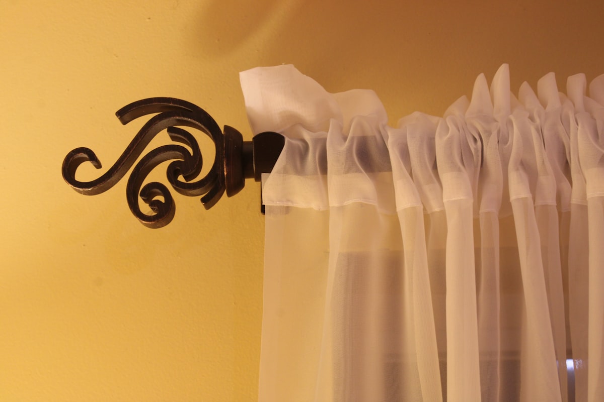 a curtain is hanging on the side of a window related to How to Hang Curtains with Valance