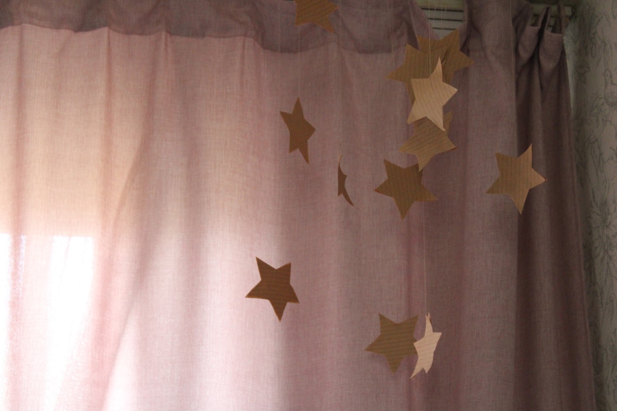 a curtain with gold stars hanging from it related to DIY Curtain Valances: A Step-by-Step Guide