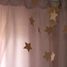 a curtain with gold stars hanging from it related to DIY Curtain Valances: A Step-by-Step Guide