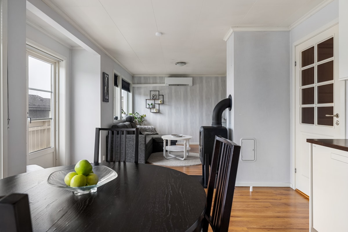 A dining room table with a bowl of fruit on it related to Maximizing Space and Comfort with Lowe's Bed Risers