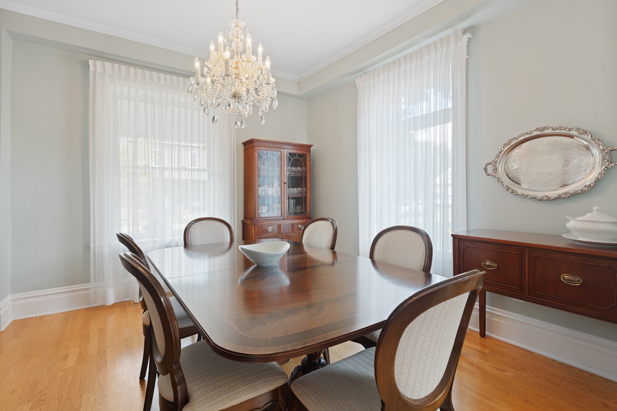 a dining room table with chairs and a china cabinet related to Elegant Window Treatments with Park Designs Valance